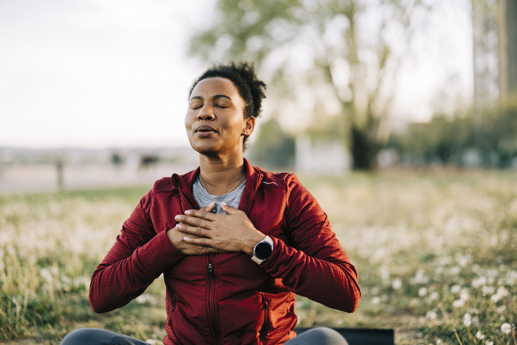 Black woman, breath and hand on chest, for meditation and wellness being peaceful to relax. Bokeh, African American female and lady outdoor, in nature and being calm for breathing exercise and health Black woman, breath and hand on chest, for meditation and wellness being peaceful to relax. Bokeh, African American female and lady outdoor, in nature and being calm for breathing exercise and health
